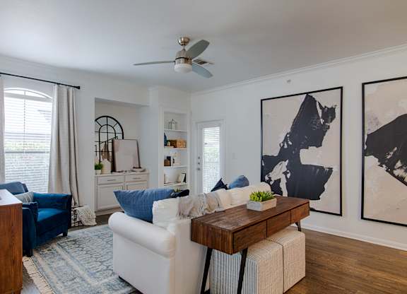 Living room with large abstract artwork and furnishings at Silverado Apartments, Frisco, Texas
