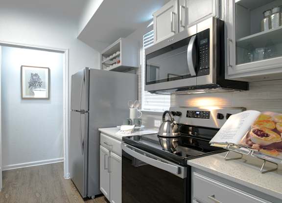 Galley kitchen with stainless steel appliances at Silverado Apartments, Frisco, TX
