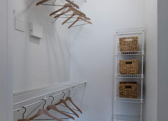 Walk-in closet with wire shelving and storage baskets at Silverado Apartments, Texas