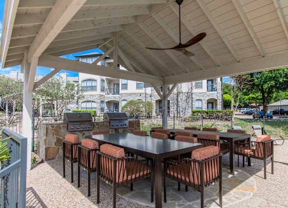 Covered outdoor dining area with barbecue grills at Silverado Apartments, Frisco, TX 75034