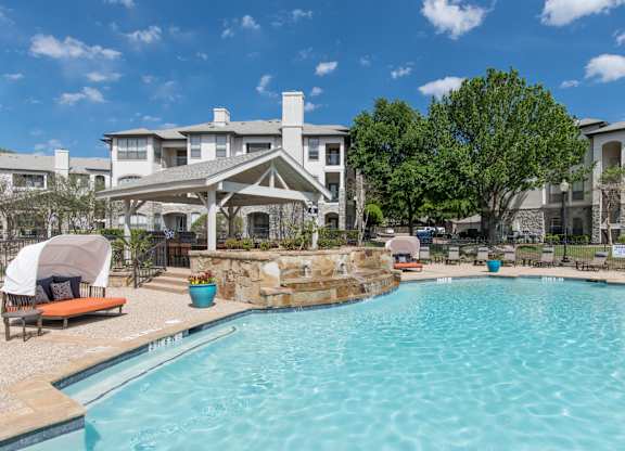 Resort style swimming pool with stone waterfall gazebo at Silverado Apartments, Frisco, TX