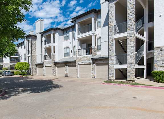 Residential building exterior with attached garages at Silverado Apartments, Frisco, 75034