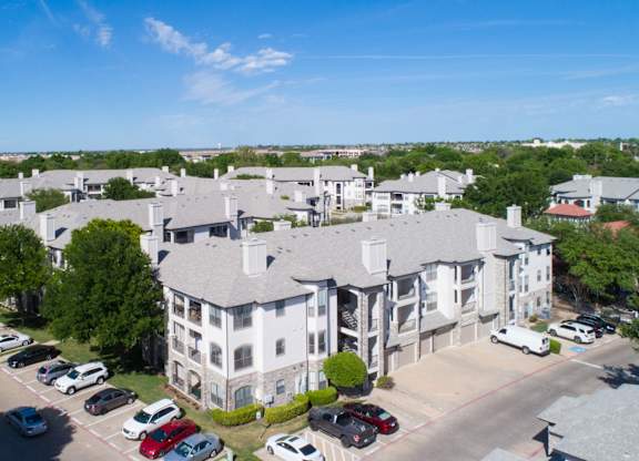Aerial view of apartment buildings with parking at Silverado Apartments, Frisco