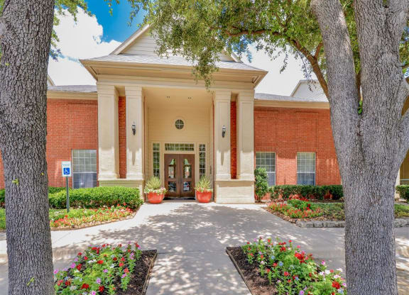 Lush entrance to Montfort Place in North Dallas, TX, For Rent. Now leasing 1 and 2 bedroom apartments.