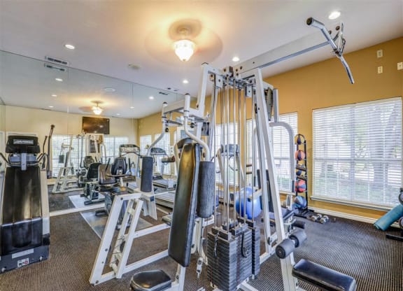 Fitness center Gym at Trinity Square Apartments in North Dallas, TX, For Rent. Now leasing 1 and 2 bedroom apartments.