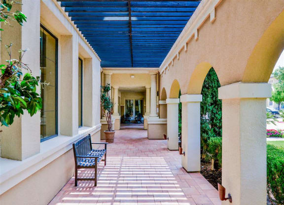 Walking paths with seating at Mission at La Villita Apartments in Irving, TX offers 1, 2 & 3 bedroom apartment homes with appliances.