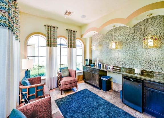 Spacious clubhouse with coffee bar at Mission at La Villita Apartments in Irving, TX offers 1, 2 & 3 bedroom apartment homes with appliances.