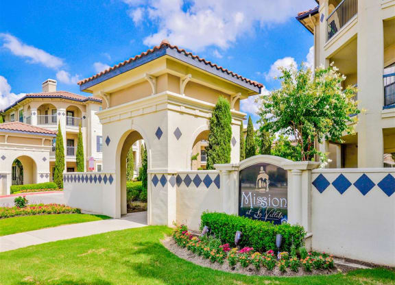 Community entrance at Mission at La Villita Apartments in Irving, TX offers 1, 2 & 3 bedroom apartment homes with appliances.