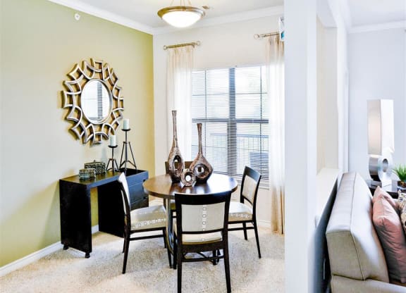 Spacious dining room with bright windows at Mission at La Villita Apartments in Irving, TX offers 1, 2 & 3 bedroom apartment homes with appliances.