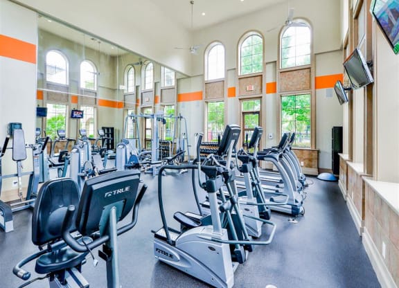 High energy fitness center fully equipped with fitness equipment in the Mission at La Villita Apartments in Irving, TX