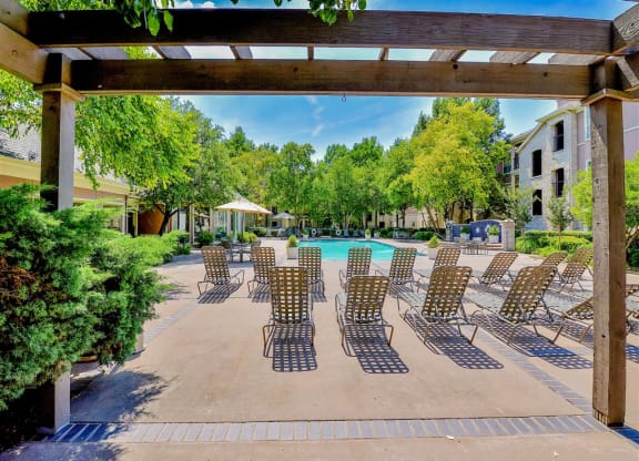 Resort pool chairs at  Bentley Place at Willow Bend Apartments in West Plano, TX, For Rent. Now leasing 1, 2, and 3 bedroom apartments.