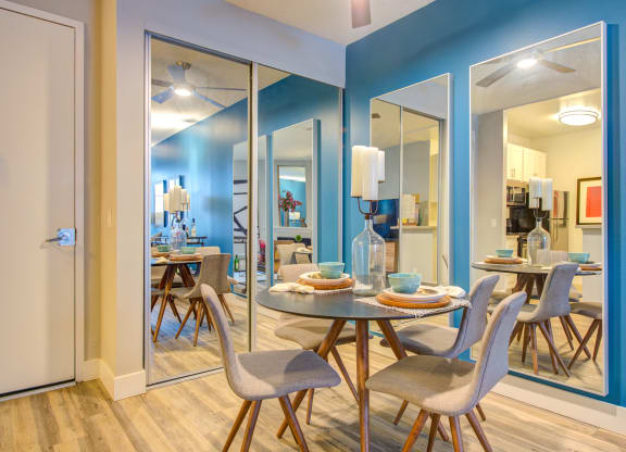 a dining room with a table and chairs