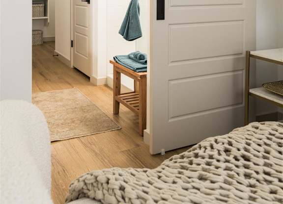 a bedroom with a bed and a closet with a white door at Villas on Ash, Gilbert