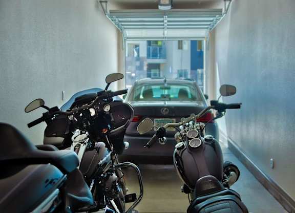 apartment garage showing two motorcycles in the foreground and Carat Craft at Gilbert and Baseline, Mesa, 85204