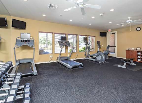 A gym with treadmills, weights, and exercise equipment. at Superstition Canyon Apartments, Mesa, AZ, 85209