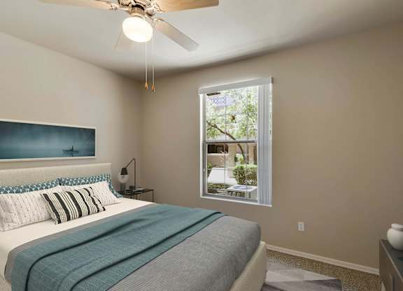 A bedroom with a bed, a ceiling fan, and a window. at Superstition Canyon Apartments, Arizona