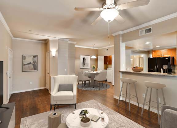 A modern living room with a white ceiling fan and a grey rug at Superstition Canyon Apartments, Mesa, 85209