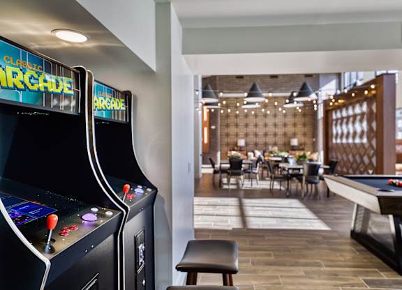 a clubhouse with a pool table and arcade games at Elevation at the Village, Gilbert Arizona