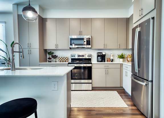 a kitchen with stainless steel appliances and white cabinets at Elevation at the Village, Gilbert, AZ 85295