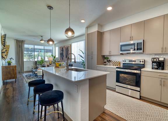 an open kitchen with an island and stools at Elevation at the Village, Arizona