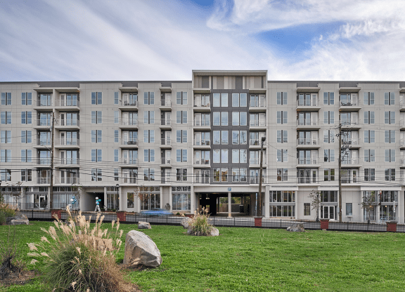 a large apartment building with a grassy area in front of it at Link Apartments® Canvas, Georgia