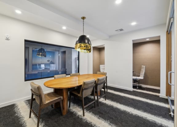 a dining room with a wooden table and chairs at Link Apartments® Broad Ave, Tennessee