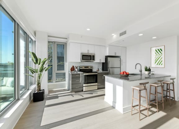 a kitchen with a large island and a large window  at Link Apartments® H Street, Washington