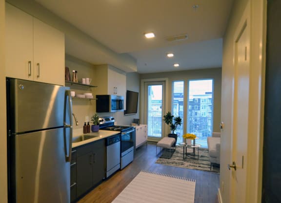 a kitchen and living room in a 555 waverly unit at Link Apartments® Canvas, Atlanta, 30312