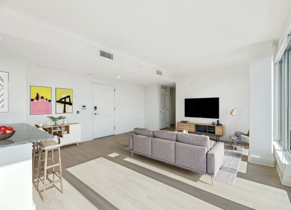 a living room with a couch and a tv  at Link Apartments® H Street, Washington, DC