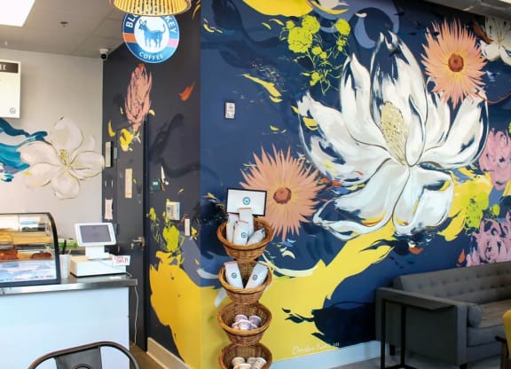 a mural of flowers on a blue and yellow background at Link Apartments® Canvas, Atlanta, GA