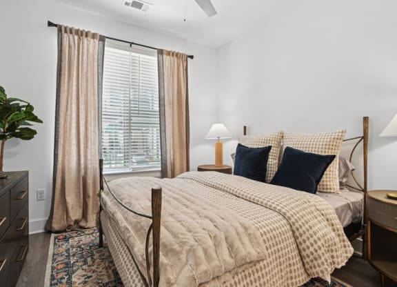 a bedroom with a bed and a large window