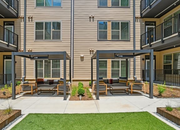 a patio with furniture in front of a building