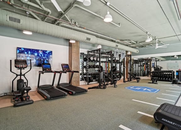a workout room with weights and other exercise equipment in a building