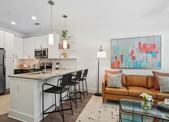 a living room with a kitchen and a table
