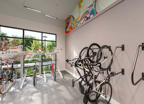 a room with bikes hanging on the wall and a window