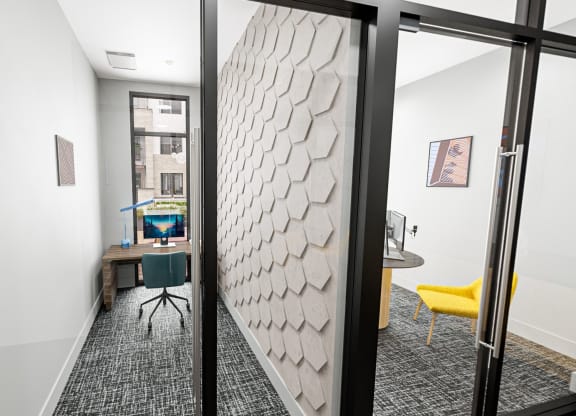a view of a room with a desk and a door