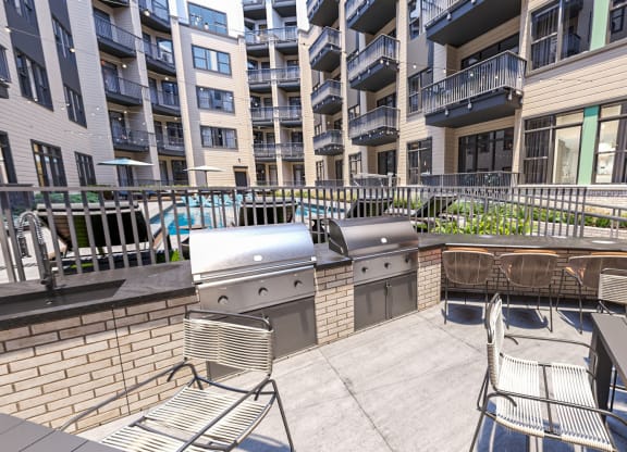 a patio with a grill and chairs and an apartment building