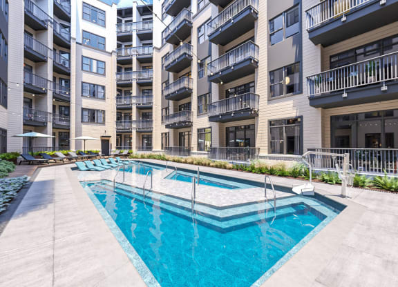 a swimming pool in the middle of an apartment building