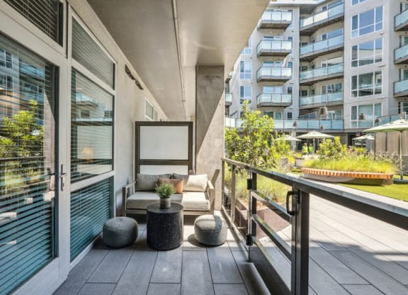 the condo has a private balcony with a view of the city at Link Apartments® Four 12, Oakland, 94607