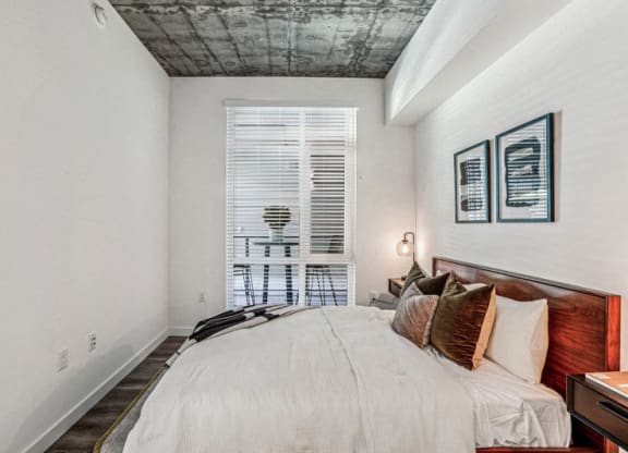 a bedroom with a large bed and a window at Link Apartments® Four 12, Oakland, CA, 94607