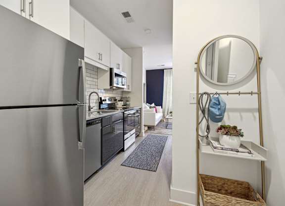 a kitchen with stainless steel appliances and a stainless steel refrigerator at Link Apartments® Calyx, North Carolina, 27517