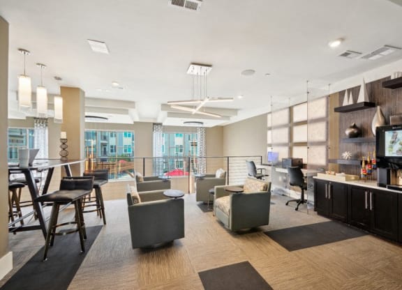 a living room with couches chairs and a bar and a television at Link Apartments® Brookstown, North Carolina, 27101