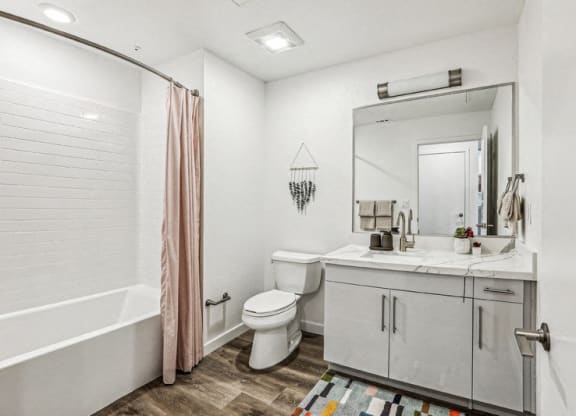 a bathroom with a shower toilet and a sink at Link Apartments® Four 12, Oakland, CA, 94607
