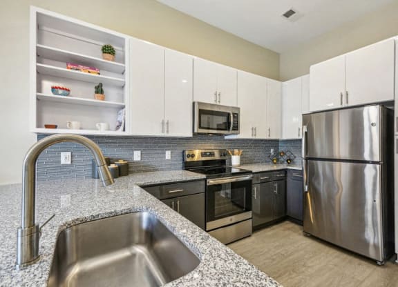 a modern kitchen with stainless steel appliances and granite counter tops at Link Apartments Innovation Quarter, Winston Salem, 27101