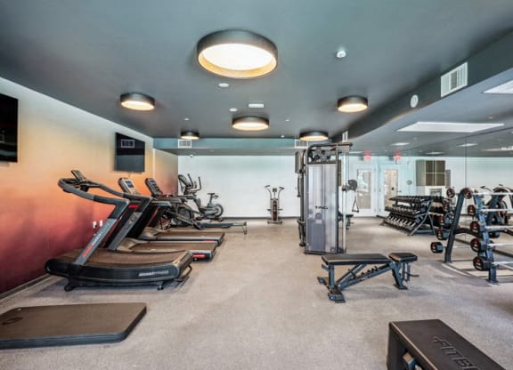 the gym with plenty of exercise equipment at the preserve at greatstone at Link Apartments® Four 12, Oakland, CA, 94607