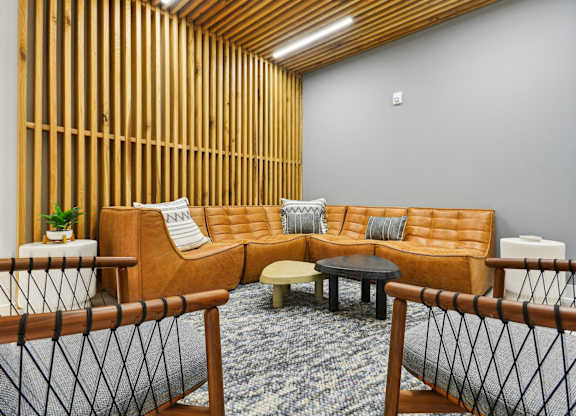 a living room with a couch and tables at Link Apartments® Calyx, North Carolina