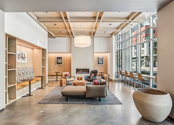 the lobby of a building with a living room and a fireplace at Link Apartments® Four 12, Oakland