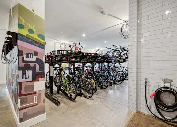 a group of bikes parked in a room with a rack of bikes at Link Apartments® Calyx, Chapel Hill, NC