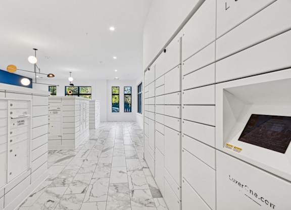 a large white closet with white cabinets and a marble floor at Link Apartments® Calyx, Chapel Hill, 27517