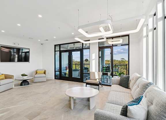 a living room with a couch and a coffee table at Link Apartments® Calyx, North Carolina, 27517